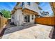 Outdoor patio features stone pavers, string lights, and a fenced perimeter for privacy and charm at 557 S Clarkson St, Denver, CO 80209