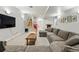 Spacious finished basement with a large sectional sofa, media center, and access to a staircase at 557 S Clarkson St, Denver, CO 80209