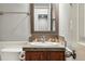 Bathroom featuring a vanity with decorative tile, modern faucet, and a brushed nickel towel bar at 557 S Clarkson St, Denver, CO 80209
