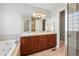 Elegant bathroom with double sinks, granite countertops, and separate tub and shower at 557 S Clarkson St, Denver, CO 80209