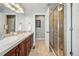 Bright bathroom featuring double sinks, granite countertops, and a glass-enclosed shower at 557 S Clarkson St, Denver, CO 80209