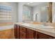 Bright bathroom with double sinks, tile countertops, and a relaxing soaking tub at 557 S Clarkson St, Denver, CO 80209