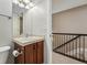 Practical bathroom with single sink, granite countertop, and stairway access at 557 S Clarkson St, Denver, CO 80209