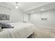 A well-lit bedroom with carpet, double-hung windows, modern light fixture, and storage cabinets at 557 S Clarkson St, Denver, CO 80209