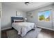 Cozy bedroom with hardwood floors, a large window, and stylish decor at 557 S Clarkson St, Denver, CO 80209