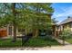 Charming home with a stone facade, well-manicured lawn, and a cozy front porch with stylish seating at 557 S Clarkson St, Denver, CO 80209