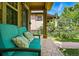 Cozy front porch with comfortable blue seating, stone flooring, and charming architectural details at 557 S Clarkson St, Denver, CO 80209