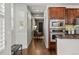 Bright hallway with hardwood floors, plantation shutters, and convenient access to modern kitchen appliances at 557 S Clarkson St, Denver, CO 80209