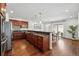 Modern kitchen featuring dark wood cabinetry, stainless steel appliances, and open to dining area at 557 S Clarkson St, Denver, CO 80209