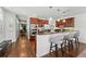 Stylish kitchen with breakfast bar, cherry cabinets, and stainless appliances open to hallway at 557 S Clarkson St, Denver, CO 80209