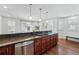 Bright kitchen with pendant lighting, granite countertops, and stainless steel dishwasher at 557 S Clarkson St, Denver, CO 80209