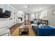 Bright living room with hardwood floors, fireplace, and comfortable blue sofa at 557 S Clarkson St, Denver, CO 80209