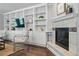 Cozy living room featuring a fireplace, built-in shelving, and a comfortable chair at 557 S Clarkson St, Denver, CO 80209