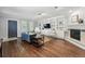 Bright living room featuring hardwood floors, custom built-in shelving, and a cozy fireplace at 557 S Clarkson St, Denver, CO 80209