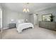 Serene main bedroom with neutral tones, a large dresser, and a chandelier at 557 S Clarkson St, Denver, CO 80209