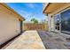 A backyard patio features decorative stone pavers, string lights, and a fenced perimeter for privacy at 557 S Clarkson St, Denver, CO 80209