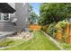 A landscaped backyard featuring a garden, grass area, and privacy fence at 6772 Tiger Tooth, Littleton, CO 80124