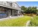 This backyard has a patio area, lush lawn, and well-maintained landscaping at 6772 Tiger Tooth, Littleton, CO 80124