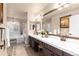 Spacious bathroom with double sinks, large mirror, soaking tub, and tiled floors at 6772 Tiger Tooth, Littleton, CO 80124