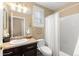 Neutral bathroom featuring a shower/tub combo, white tiled walls, and a classic dark vanity at 6772 Tiger Tooth, Littleton, CO 80124