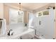 This bathroom features a soaking tub, walk-in shower, and bright natural light at 6772 Tiger Tooth, Littleton, CO 80124