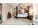 Primary bedroom suite featuring a four-poster bed, sitting area, and neutral colors at 6772 Tiger Tooth, Littleton, CO 80124