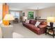 Bonus room has a leather couch and pillows with a view of trees outside at 6772 Tiger Tooth, Littleton, CO 80124