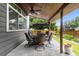 This covered patio has an outdoor dining area and ceiling fan at 6772 Tiger Tooth, Littleton, CO 80124