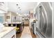 Open-concept kitchen boasts stainless steel appliances, granite countertops, pendant lighting, and hardwood floors at 6772 Tiger Tooth, Littleton, CO 80124