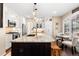 Kitchen island with bar seating, granite counters, and breakfast nook with window seating at 6772 Tiger Tooth, Littleton, CO 80124