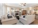 Cozy living room features a fireplace, built-in shelves, ceiling fan, and comfortable seating at 6772 Tiger Tooth, Littleton, CO 80124