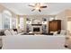 Bright living room featuring a fireplace, built-in shelves, large windows, and comfortable seating at 6772 Tiger Tooth, Littleton, CO 80124