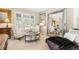 Bright living room features neutral walls, light carpet, stylish furniture, and abundant natural light through window shutters at 6772 Tiger Tooth, Littleton, CO 80124