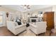 Cozy living room boasts hardwood floors, a fireplace, stylish decor, and plantation shutters at 6772 Tiger Tooth, Littleton, CO 80124