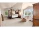 Spacious main bedroom with sitting area, large windows, ceiling fan, and four-poster bed at 6772 Tiger Tooth, Littleton, CO 80124