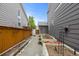Narrow side yard featuring raised garden beds and grey siding at 6772 Tiger Tooth, Littleton, CO 80124