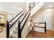 Entryway boasts hardwood floors, a staircase with dark wood trim, and a view into the living room at 6772 Tiger Tooth, Littleton, CO 80124