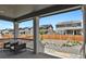Cozy back porch with seating offers a view of the landscaped backyard and neighboring houses at 24555 E Ohio Dr, Aurora, CO 80018
