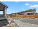 Landscaped backyard with decorative rock, wooden fence and view of the back of neighboring houses at 24555 E Ohio Dr, Aurora, CO 80018