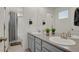 Bathroom with dual sinks, gray cabinets, and a separate shower area at 24555 E Ohio Dr, Aurora, CO 80018