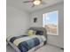 Cozy bedroom with a ceiling fan and view of houses outside the window at 24555 E Ohio Dr, Aurora, CO 80018