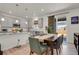 Well-lit dining area with modern table and chairs, open to the kitchen and featuring stylish light fixtures at 24555 E Ohio Dr, Aurora, CO 80018