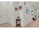 Bright entryway featuring white walls, light wood flooring, and decorative wall art pieces at 24555 E Ohio Dr, Aurora, CO 80018