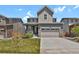 Charming two-story home with a two-car garage, landscaped yard, and welcoming front porch at 24555 E Ohio Dr, Aurora, CO 80018