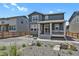 Charming two-story home with stone accents, a front porch, and a well-maintained yard at 24555 E Ohio Dr, Aurora, CO 80018