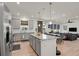Open-concept kitchen with stainless steel appliances, granite countertops, connecting to the dining area and living room at 24555 E Ohio Dr, Aurora, CO 80018