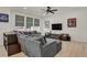 Contemporary living room features a large sectional sofa, modern decor, and natural light from multiple windows at 24555 E Ohio Dr, Aurora, CO 80018
