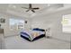 Spacious bedroom featuring tray ceiling, carpet flooring, and large window at 24555 E Ohio Dr, Aurora, CO 80018