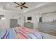Bedroom with a ceiling fan, TV, gray dresser, and neutral decor at 24555 E Ohio Dr, Aurora, CO 80018