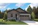 Charming single-Gathering home showcasing a stone facade, complemented by a well-manicured lawn and an attached two-car garage at 2657 Sawyer Ln, Erie, CO 80026